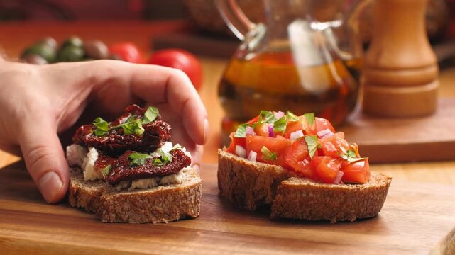 Italian sandwich bruschetta with sun dried tomatoes, fresh tomatoes and cream cheese, close up of Italian appetizer on farm bread with olive oil, Spanish tapas and pinchos