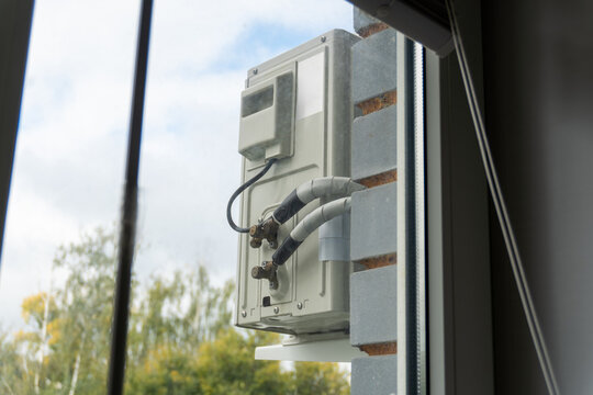 Air conditioner outdoor unit mounted on balcony building facade