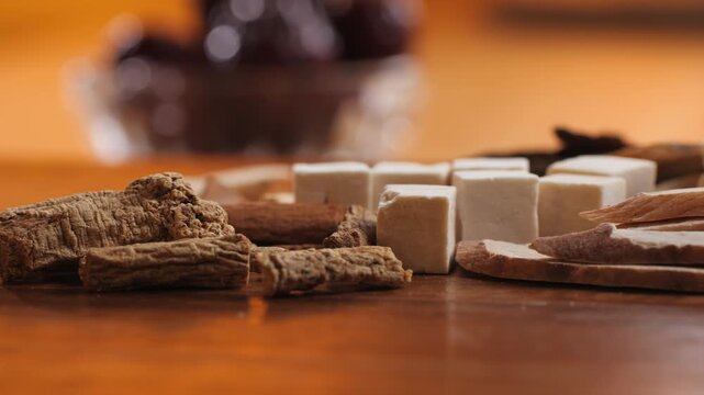 Chinese herbal soup ingredients Shi Quan Da Bu Tang, close up of ten dried herbs, poria cubes, licorice, astragalus and angelica root, traditional Chinese medicine tonic