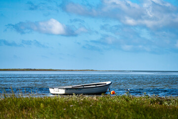 White rowing boat moored in shallow water on Læsø coast © René Dyhr