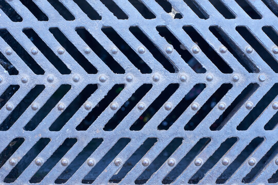 Metal grate texture forming a repeating pattern background