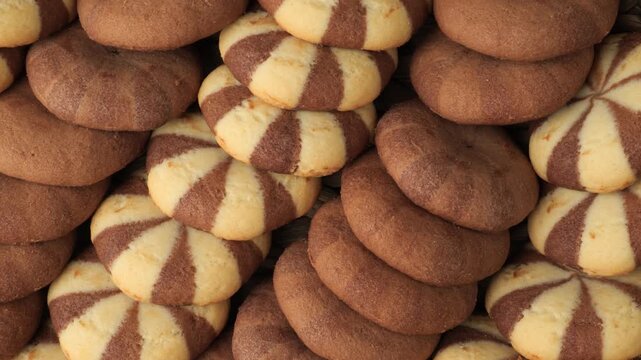 Delicious chocolate and vanilla cookies sliding sideways