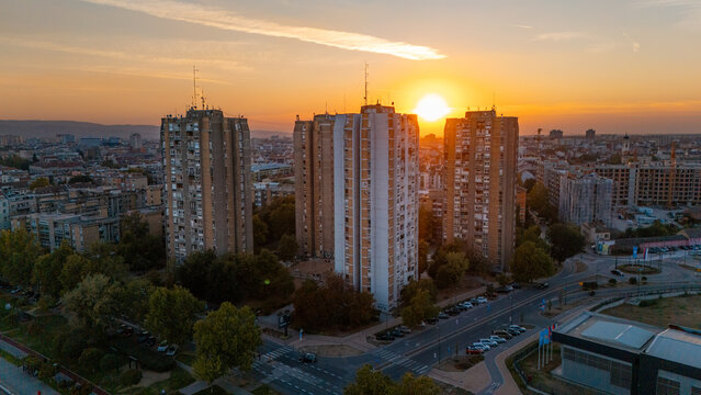 Aerial view of residential towers in Novi Sad during golden hour with warm sunset light illuminating the cityscape in Novi Sad, Vojvodina, Serbia.