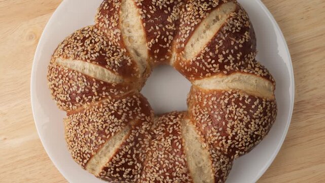 Crown shaped pretzel bread with sesame seeds rotating
