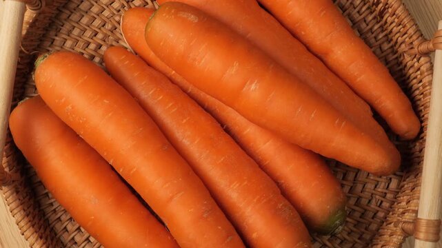 Fresh organic carrots rotating in a basket