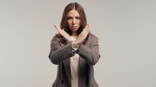 Confident woman making firm no gesture by crossing hands. Student, college or professional businesswoman refusing offer, personal boundaries