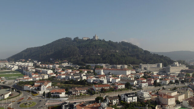 Aerial view of the Sanctuary of the Sacred Heart of Jesus on a green hill overlooking the white rooftops and urban landscape of Viana do Castelo, Viana do Castelo Dist, Portugal.
