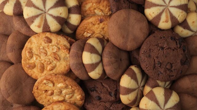Delicious mixed sweet cookies rotating background