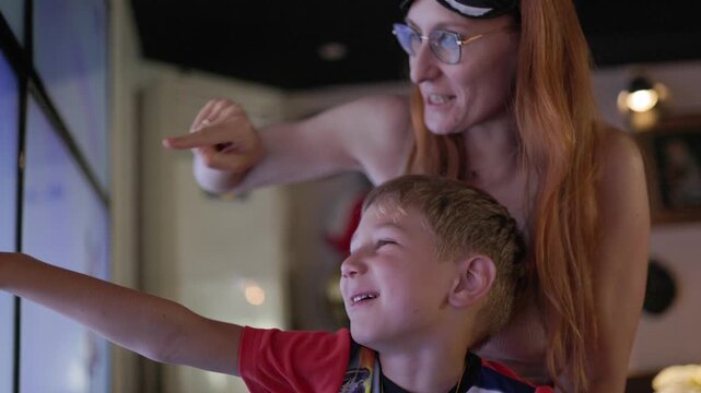 Mother and son exploring interactive touchscreen exhibit