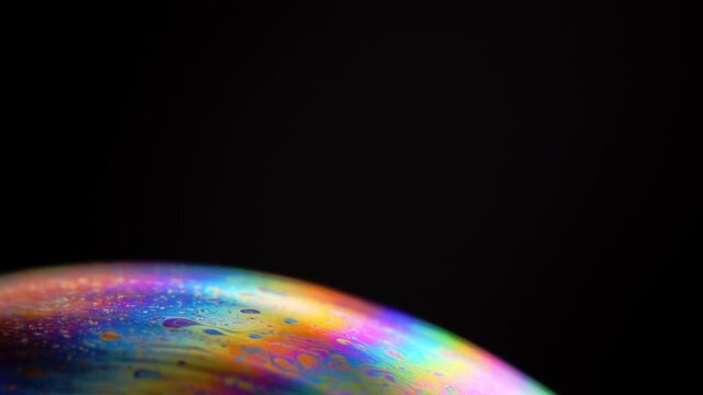 Rainbow multilayer film. Spherical abstraction of iridescent blue, yellow and red colors with soft focus. The natural environment.