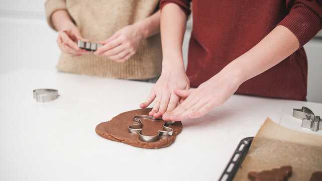 Sisters Baking Gingerbread Cookies For A Christmas Celebration