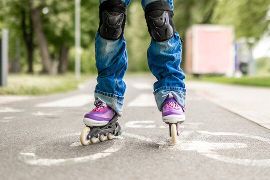 Inline skater wearing protective gear on paved path