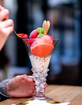 Eating delicious strawberry ice cream parfait