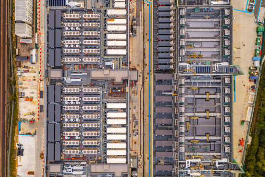 Aerial view of NTT LON1B Data Centre featuring rows of industrial cooling units and technical infrastructure in Dagenham, England, United Kingdom.