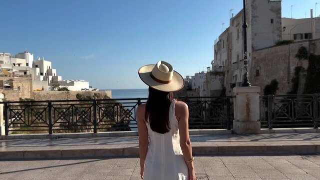 Woman Walking to a Seaside Viewpoint in Polignano a Mare, Italy