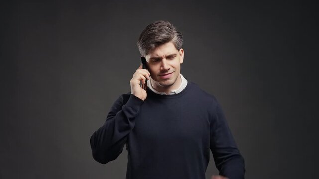 Cheerful man speaks on mobile phone, showing friendliness and warmth.Positive communication moment. Happy Adult Guy Talking On Smartphone