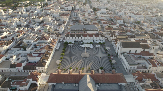 Aerial view of the geometric patterned Praca Marques de Pombal with its central obelisk and historic white buildings in Vila Real de Santo Antonio, Faro District, Portugal.