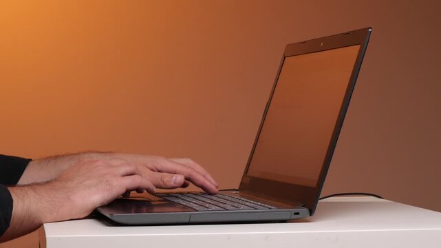 Person's hands typing on a laptop keyboard, representing concepts of remote work, technology, online communication, and digital connectivity in a modern office or home setting