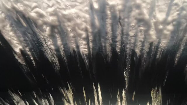 Automatic Car Wash View From Inside Vehicle. Modern automotive care services, vehicle maintenance routines, automated cleaning technology, driving visibility safety, fresh starts, water conservation
