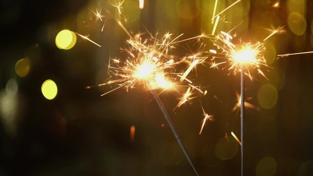 Lighting festive sparklers, Happy new year celebration.