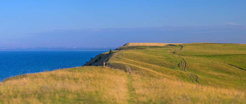 Panoramic rolling coastal hills and winding countryside trails.