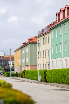 Colorful Scandinavian apartment buildings lining quiet residential street.