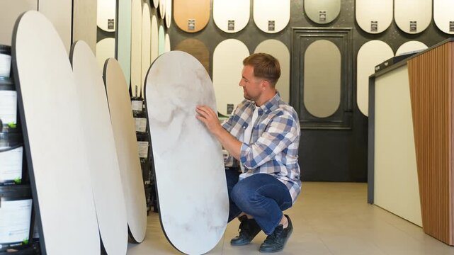 Designer selecting decorative plaster panel for interior design