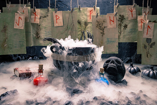 Spooky skull stands beside a steaming cauldron.