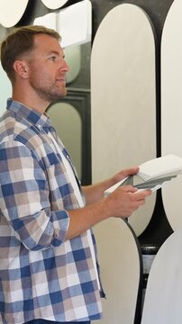 Designer selecting decorative plaster samples for interior renovation