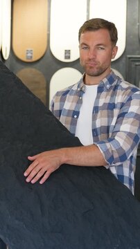 Male interior designer choosing black natural stone tile