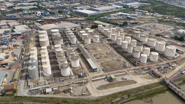 Aerial view of the Navigator Terminals Thames industrial storage facility featuring numerous large white storage tanks, pipelines, and infrastructure in Grays, England, United Kingdom.
