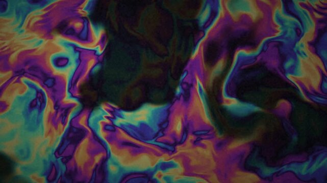 Oil slick rainbow swirls on dark surface slowly moving, psychedelic iridescent 4K looping background