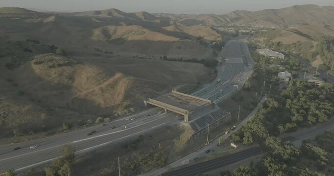 Aerial view of freeway with overpass bridge in hazy hills