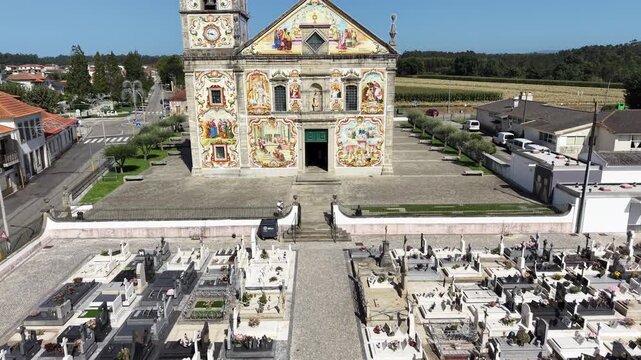 V&aacute;lega church showcasing colorful azulejo tiles on its exterior facade under clear sky