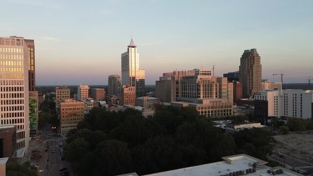Aerial approach shot of the downtown Raleigh, North Carolina skyline at sunset