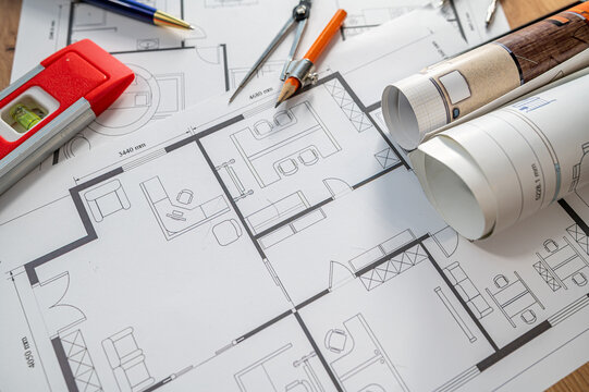 House Blueprint Project Layout with Construction Spirit Level and Drafting Compasses on Wood Desk