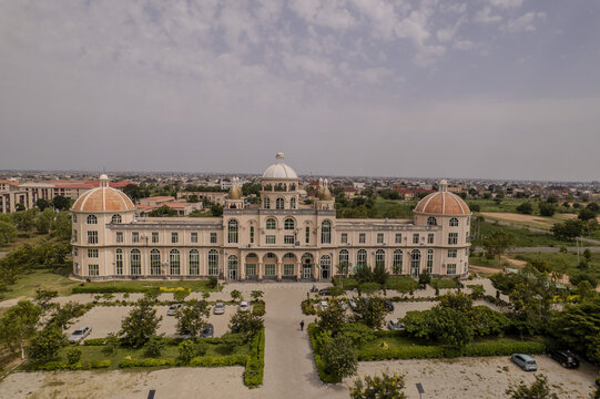 Aerial view of the Senate Building at Northwest University in Kano, featuring its distinctive domed architecture, surrounding parking areas, and lush greenery in Kano, Kano, Nigeria.