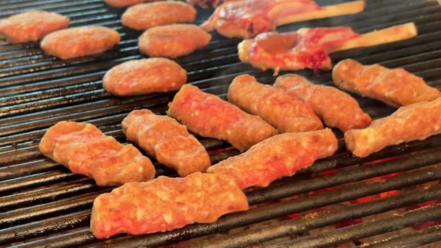 Grilling Meatballs and Lamb Chops Over a Traditional Wood Fire Barbecue