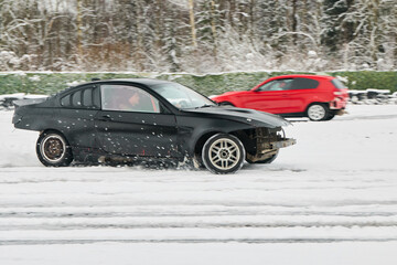 Sedan drifts through snow with spray and precise throttle control © diczman