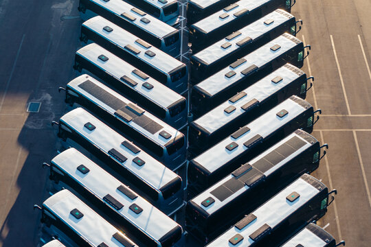 Aerial view of a large fleet of identical passenger buses parked in neat rows at a transportation depot in Jacksonville, Florida, United States.
