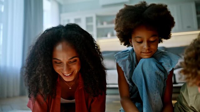 Daughter parents solving jigsaw puzzle floor. Smiling multiracial family home.
