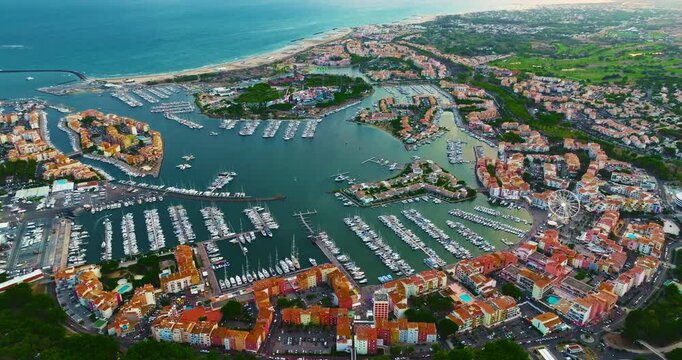 Aerial view of picturesque Mediterranean marina in the town of Agde, featuring sailing yachts. A popular seaside resort in the south of France, known for its sandy beaches, yachting