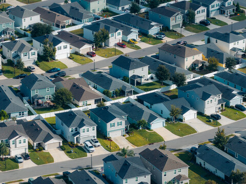 Aerial view of a suburban housing development with rows of identical residential houses, paved streets, and driveways in Jacksonville, Florida, United States.