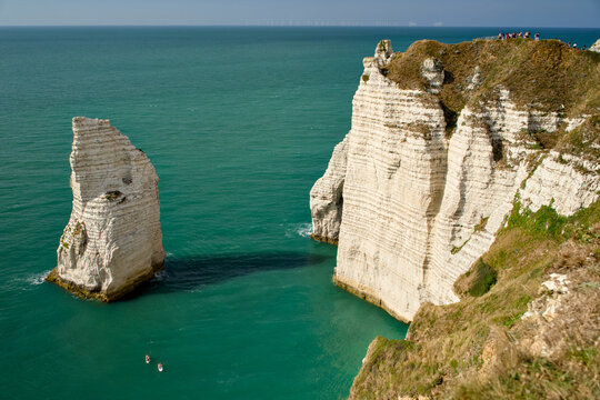 Etretat chalk sea stack and towering cliffs above turquoise sea