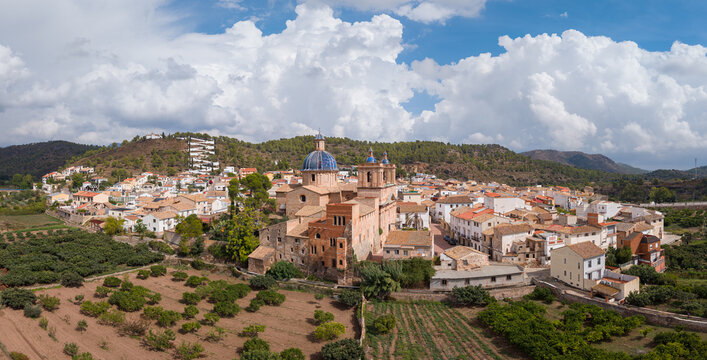 Aerial view of the Palace of Sot de Ferrer with its blue-domed church, surrounded by traditional houses, fields, and hills in Sot de Ferrer, Comunidad Valenciana, Spain.