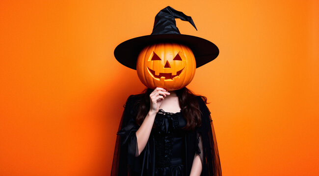 Witch with Halloween pumpkin instead of her head on orange background
