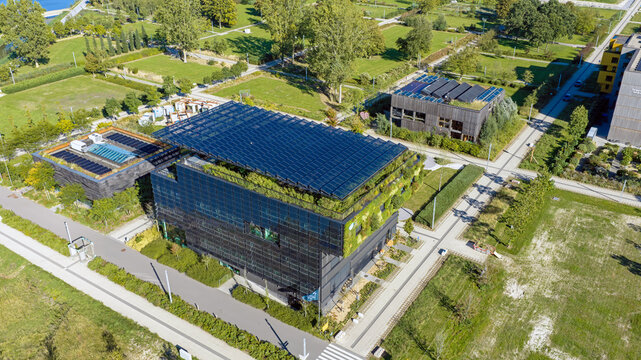 Aerial view of Aeres University of Applied Sciences Almere with green walls and solar panels surrounded by landscaped park grounds in Almere, Flevoland, Netherlands.
