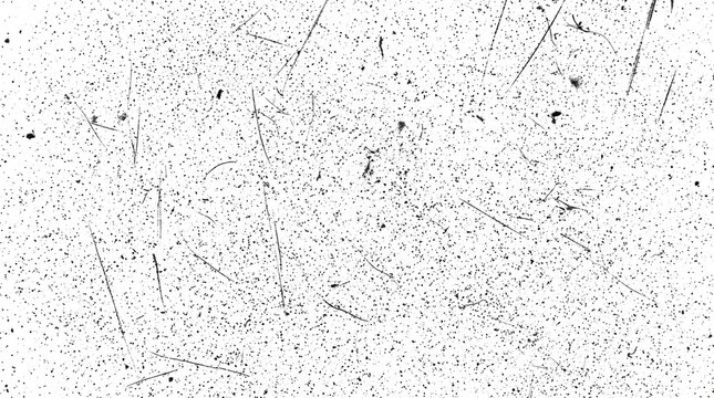 Abstract grunge texture with black scratches and dust particles on a white background.