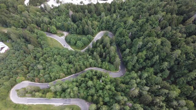 Aerial Top View of Winding Hairpin Road Through Conifer Forest on Vrsic Pass (Vr&scaron;ič Pass), Slovenia. Russian Road in Slovenian Alps. Suitable for travel, car themed ads, road triggers, wallpapering.