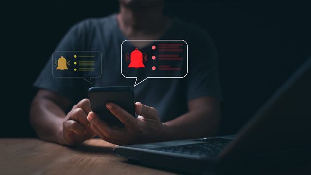 Digital notification alert concept. Person using smartphone with warning bell messages. Mobile reminders, urgent updates, system notices, communication, attention and online user engagement.